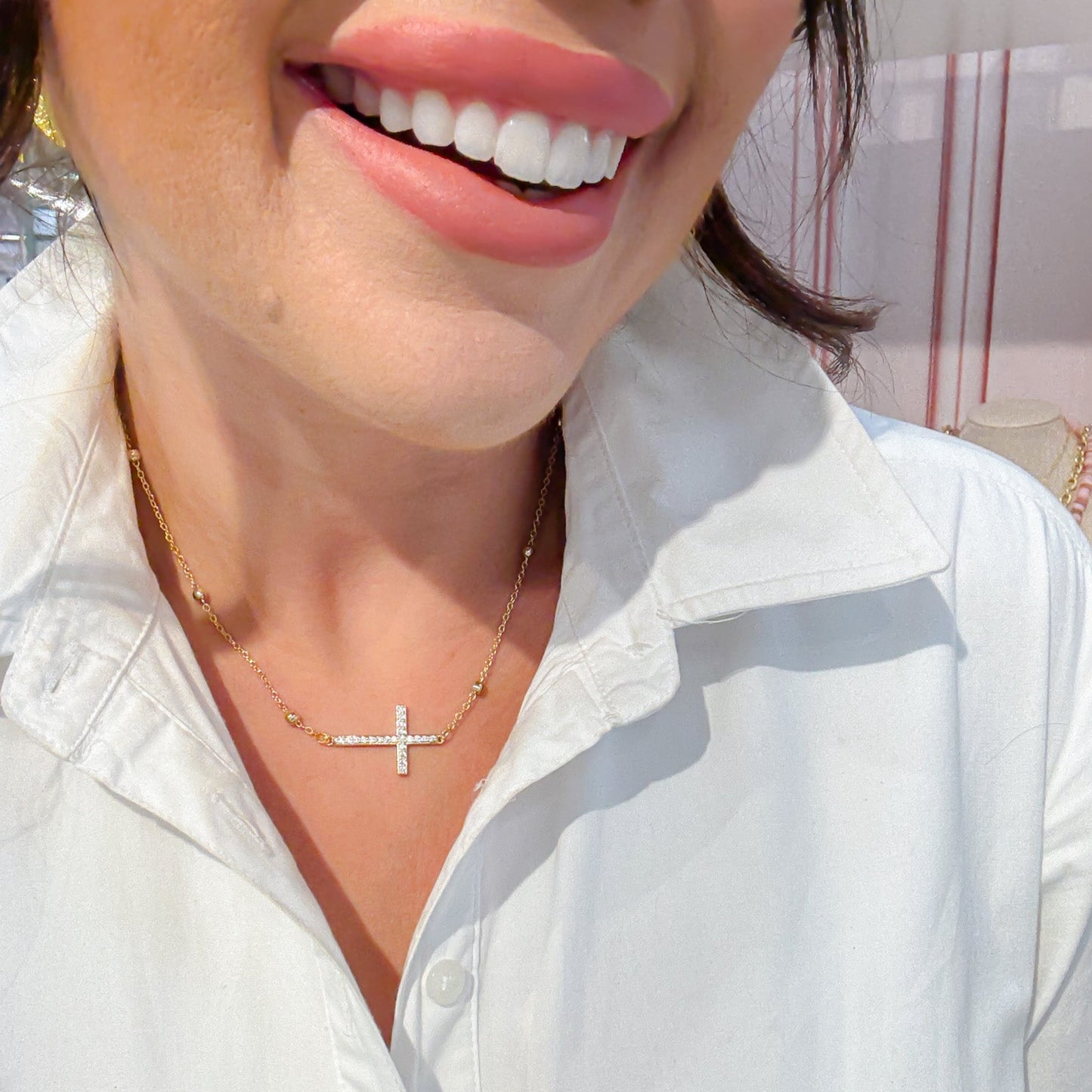 Dainty gold layered necklace with a sideways cross pendant, trendy statement accessory for wholesale jewelry for women’s boutiques and boutique wholesale jewelry, waterproof necklaces that are hypoallergenic and tarnish free