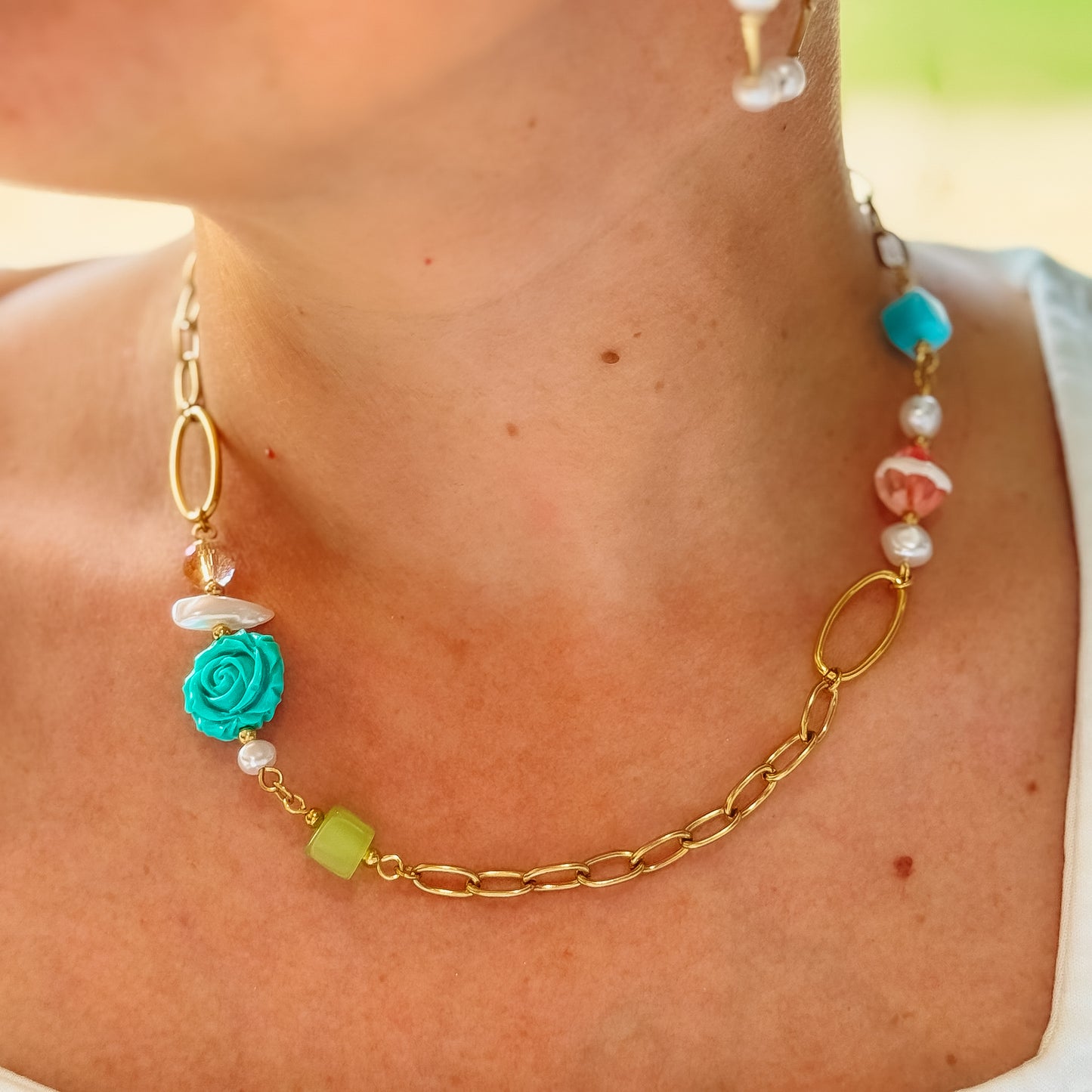 Dainty gold layered necklace featuring a mixed-bead design with a turquoise rose charm, pastel acrylic beads, faux pearls, geometric accents, and elongated gold chain links, waterproof, hypoallergenic, tarnish free, statement accessories, wholesale jewelry for women boutiques