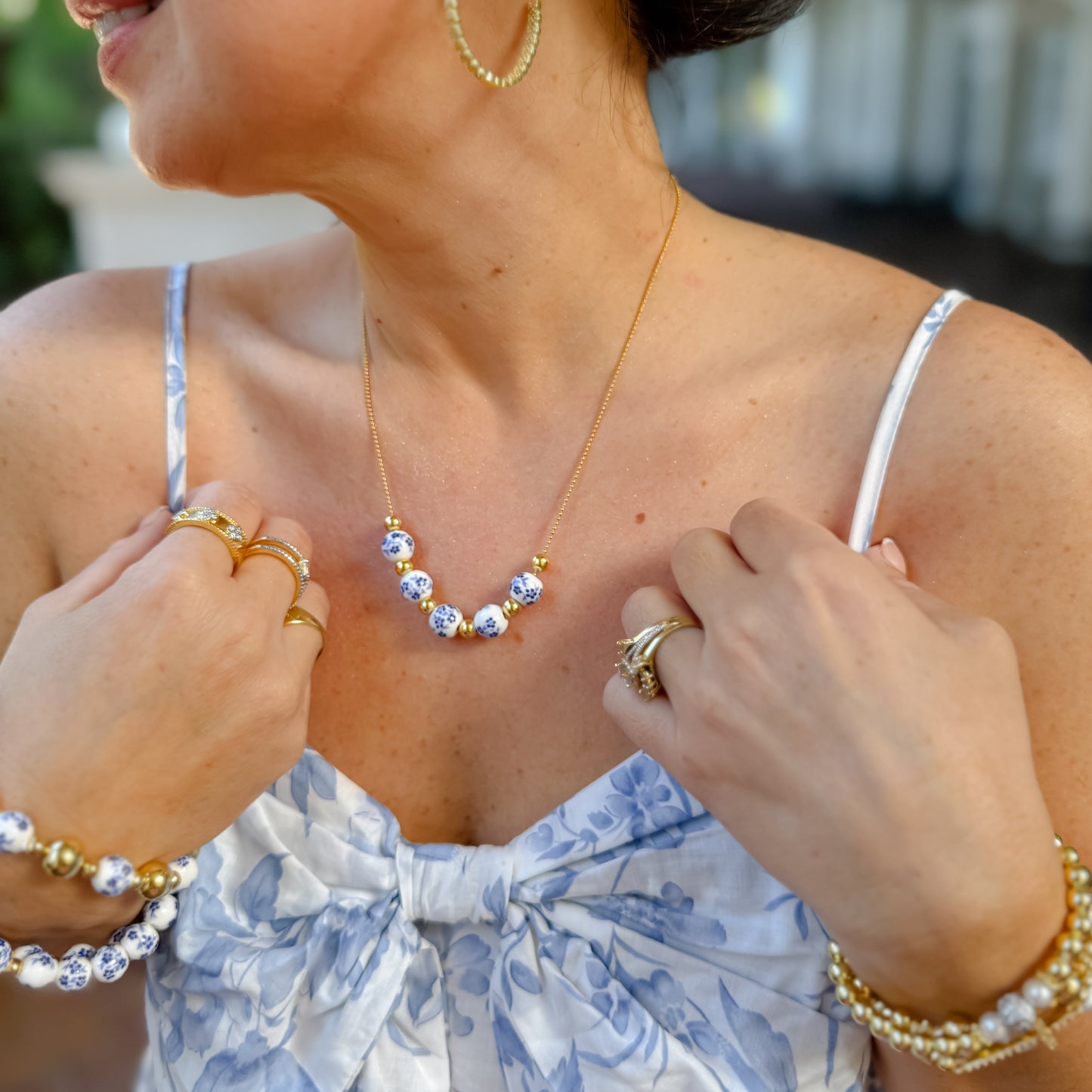 dainty gold layered necklace with blue floral ceramic beads and gold accent beads, wholesale jewelry for women boutiques, statement accessories, waterproof, hypoallergenic, tarnish free