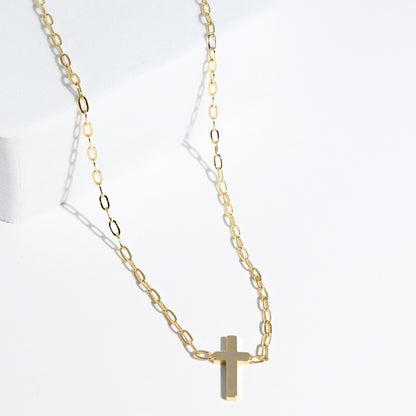 Dainty gold layered necklace with a smooth cross pendant, trendy statement accessory for wholesale jewelry for women’s boutiques and boutique wholesale jewelry, waterproof necklaces that are hypoallergenic and tarnish free