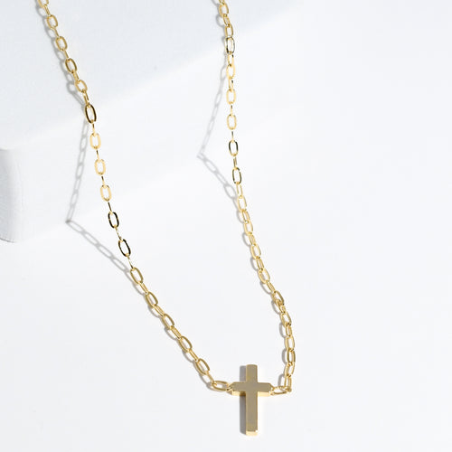 Dainty gold layered necklace with a smooth cross pendant, trendy statement accessory for wholesale jewelry for women’s boutiques and boutique wholesale jewelry, waterproof necklaces that are hypoallergenic and tarnish free
